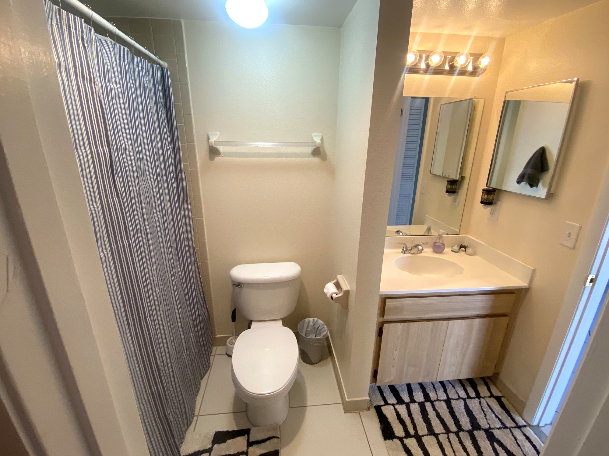 Clean full bathroom with vanity, mirror and walk-in shower