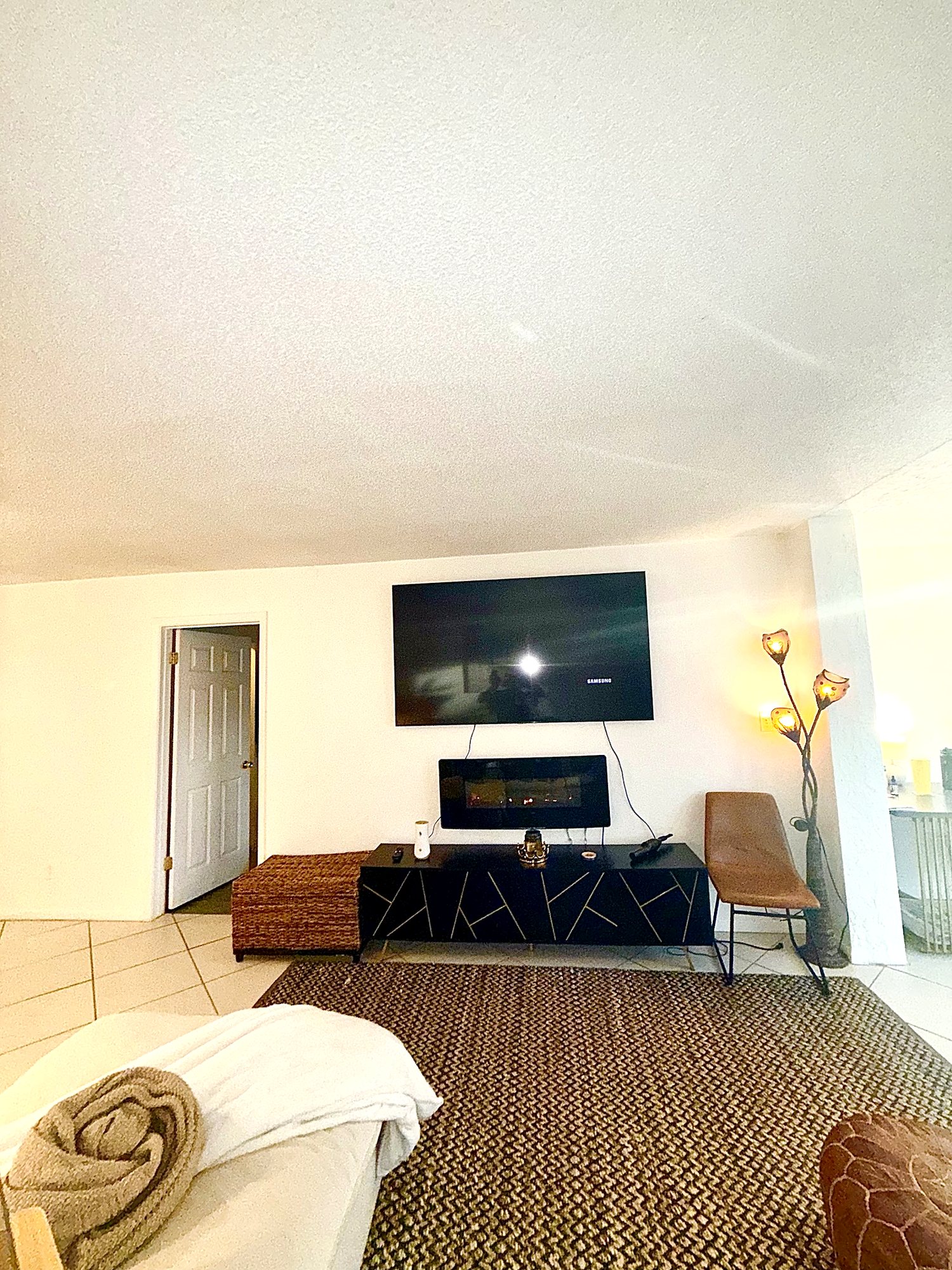 Media wall with mounted television and electric fireplace console
