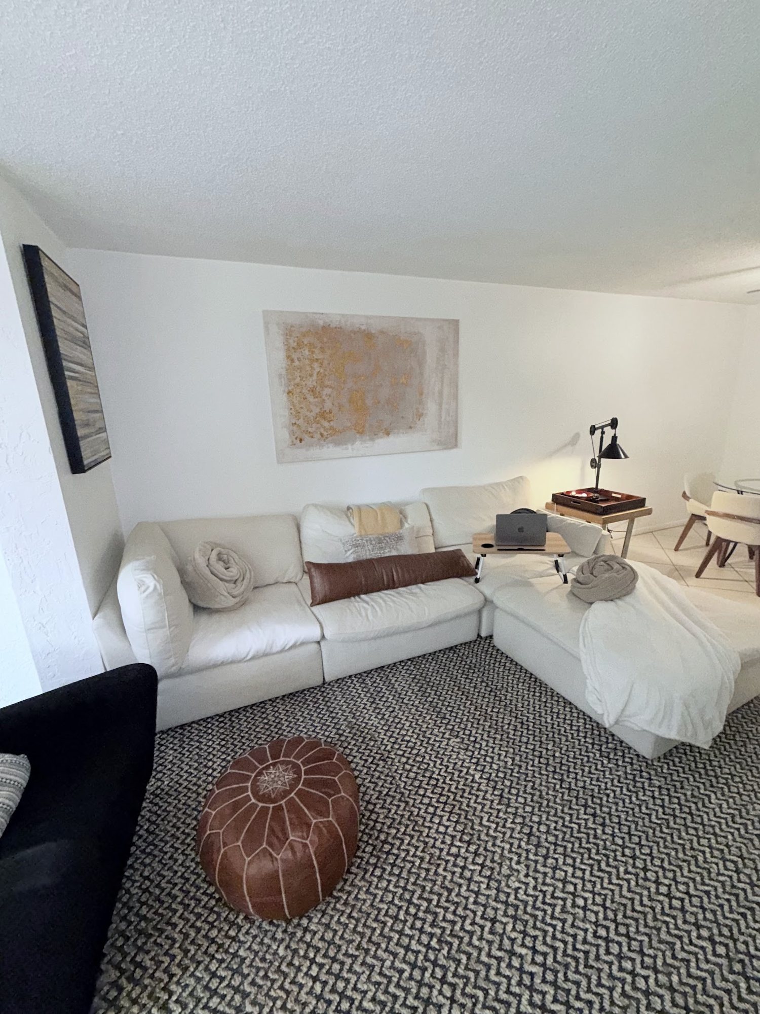 Bright furnished living room with sectional sofa and framed art at 1952 Laughing Lane